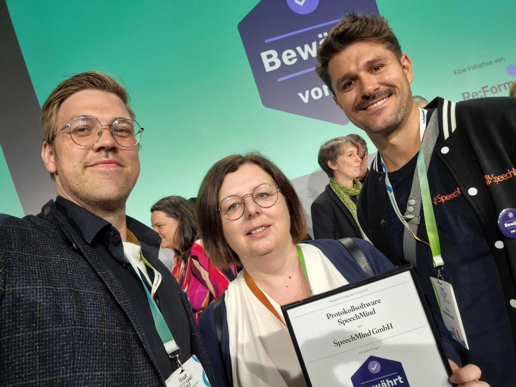 Christoph Schröder, Leiter des Referats Digitalisierung, IKT der Stadt Wertheim; Nancy Riebe, Mitarbeiterin der für Protokolle zuständigen Stabsstelle Zentrale Steuerung; Titus Hartmann von der Firma Speechmind mit Auszeichnung "Bewährt vor Ort".