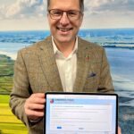 Der Landrat hält ein Tablet in den Händen, auf dessen Bildschirm die Onlineumfrage der Kreisverwaltung Stade zu sehen ist.