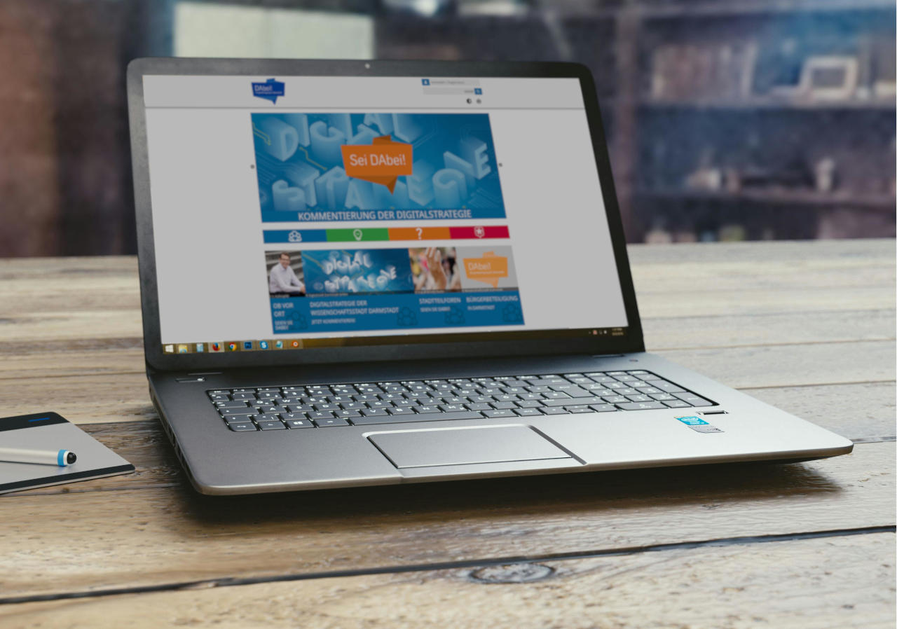 ein Laptop auf dessen Display die Website zur Beteiligungsplattform der Stadt Darmstadt aufgerufen ist