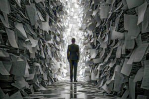 Blick von hinten auf eine männliche Figur im Anzug, die in einem Tunnel aus Papieren steht, am Ende des Tunnels ist Licht.