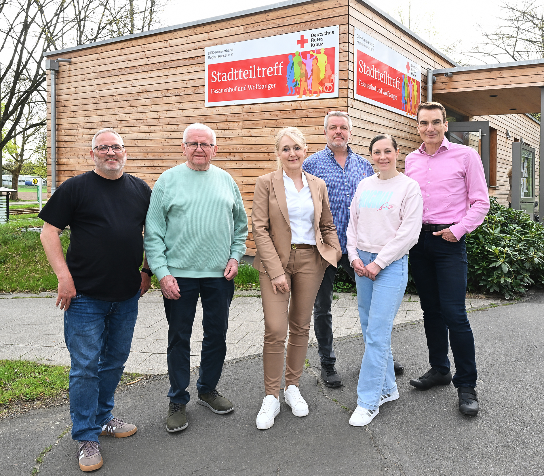 Mehrere Personen stehen vor einem Stadtteiltreff in Kassel Wolfsanger