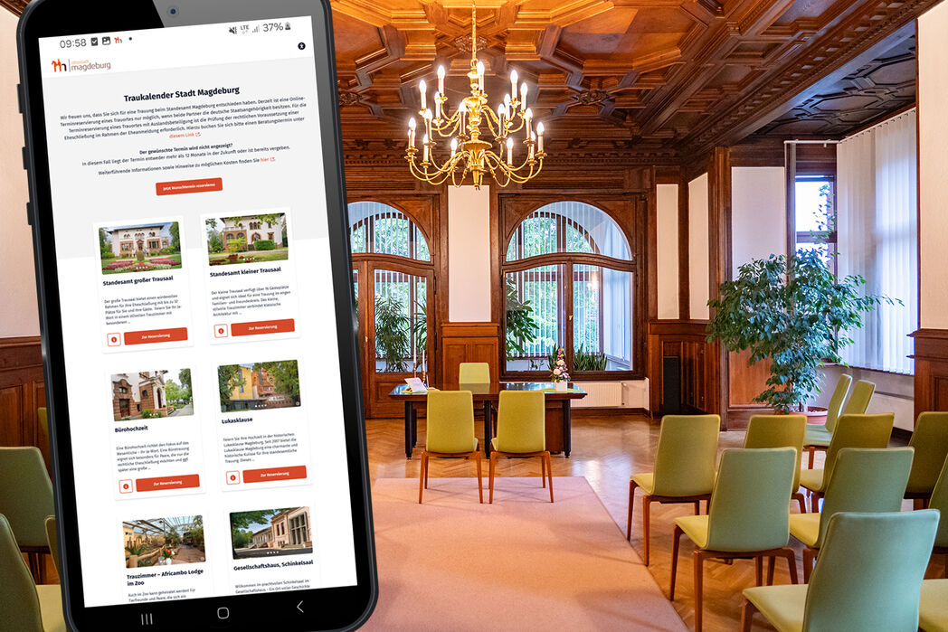 Blick in einen Trausaal der Stadt Magdeburg, im Vordergrund ein Smartphone auf dem das neue Angebot Digitaler Traukalender geöffnet ist