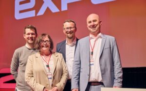 vier personen stehend_ekom21_nimmt Haiilo in Produktportfolio auf