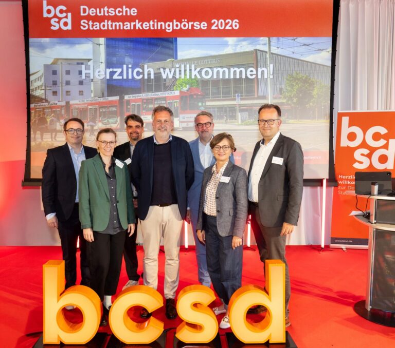 Personengruppe zum Gruppenbild aufgestellt hinter den Buchstaben "bcsd"